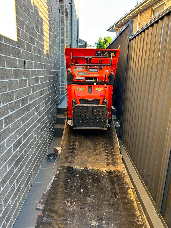 Tracked dumper carrying spoil through a narrow side passage