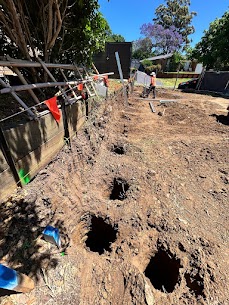 Auger-drilled pier holes ready for concrete
